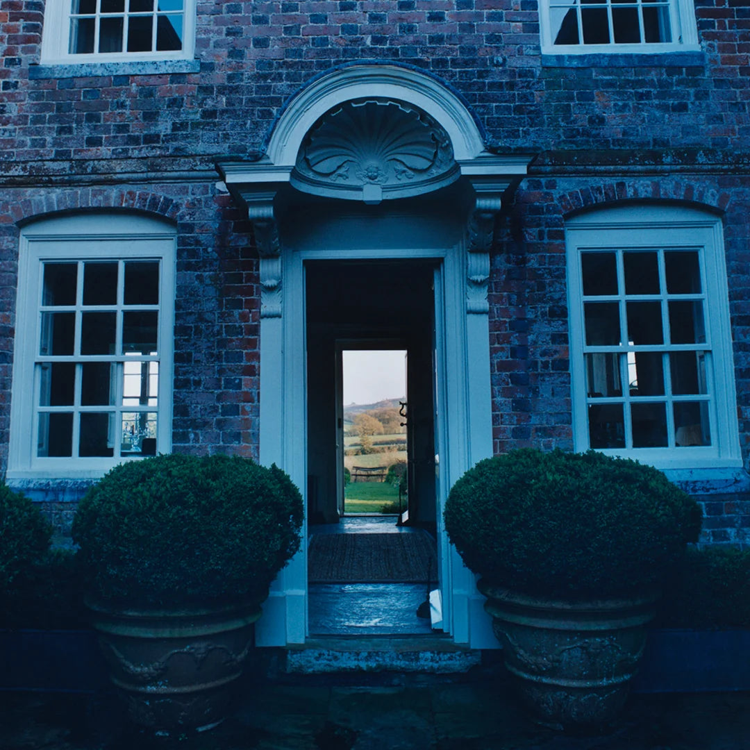 Simone Books Scenery Issue 5 magazine cover featuring a brick house entrance with topiary plants and a garden view